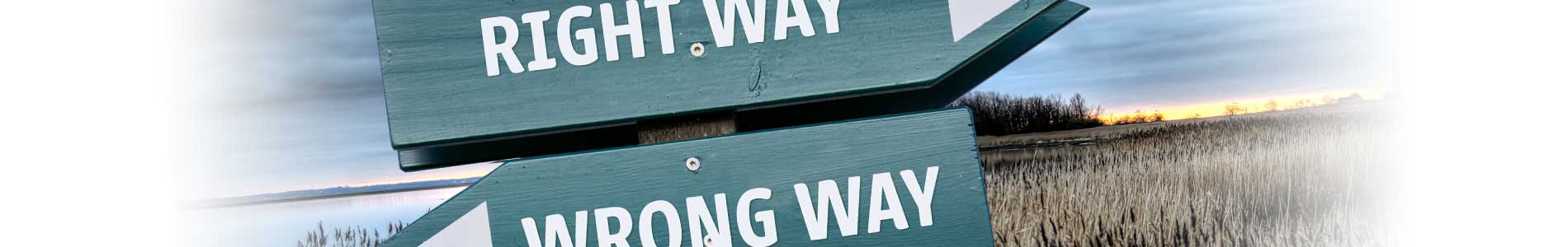 A wooden sign with two directional labels pointing in opposite directions, one saying Right Way and the other Wrong Way