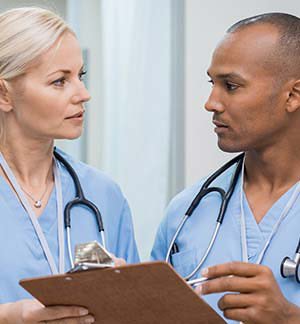 Nurses discussing patient chart